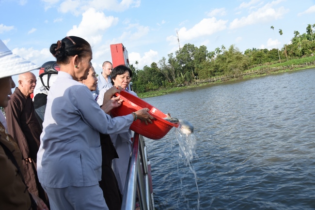 Praying for rebirth and releasing creatures in Ba Lua port, Cu Chi